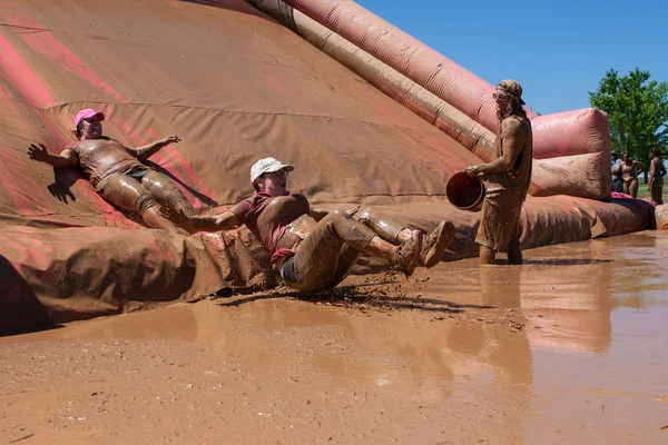 Women Slide Into Muddy Pit At Dirty Girl Mud Run — Stock Photo, Image