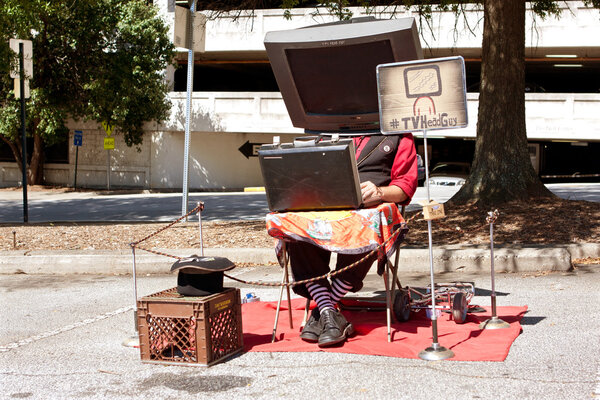 Man with Prop TV On Head Does Performance Art
 