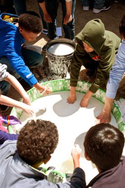 Çocuklar goo bilim fuarında küvette elinde sopa