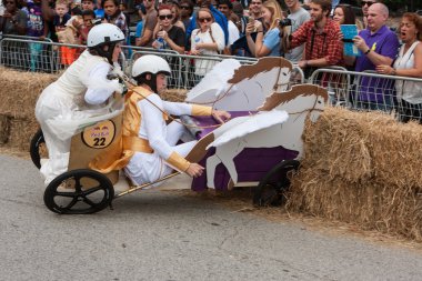 Competitors Crash Vehicle Into Hay Bales At Soap Box Derby clipart