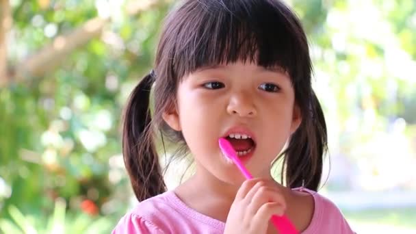 Bonito ásia menina escovar dentes sem pasta de dentes ) — Vídeo de Stock