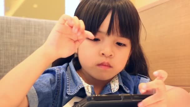 Cute Asian Girl Playing Smart Phone — Stock Video