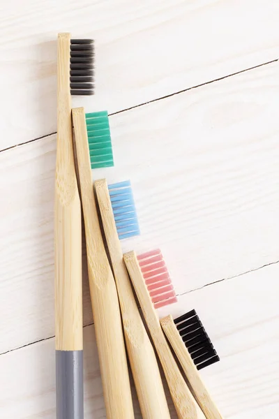 Multicolored Bamboo Toothbrushes White Wooden Table Top View — Stock Photo, Image