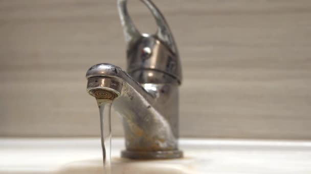 一条细细的硬水从一个旧的水龙头式曝气器中流出来 旧浴室水龙头被钙和污垢污染 — 图库视频影像