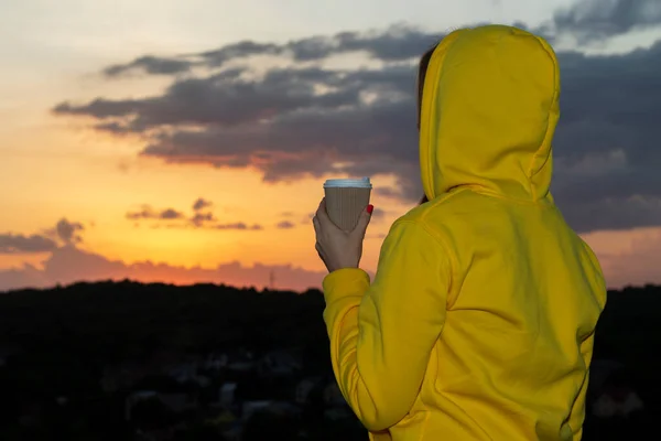 Woman Yellow Hoodie Cup Coffee Her Hand Looks Sunset — Stock Photo, Image