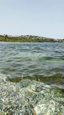 İspanya 'nın Cebelitarık kenti yakınlarında sakin dalgalar ve parlak kıyı manzarası ile çevrili plajda dinleniyor..