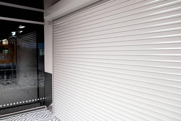 Shop window with roller shutters for protection from vandals