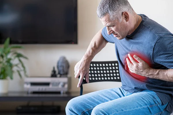 Una persona experimenta dolor en el pecho causado por un ataque al corazón. Enfermedad cardíaca. Angina de pecho. El concepto de seguro de salud para las personas mayores. —  Fotos de Stock