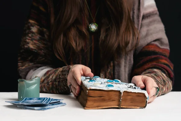 Fortune teller is reading the future with tarot cards close up.