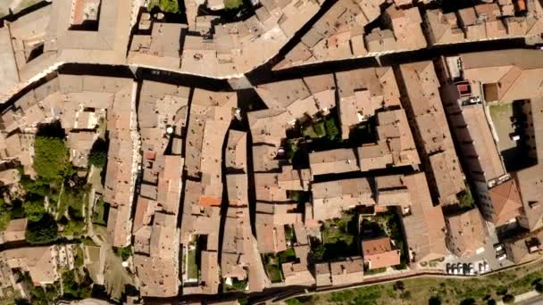 A picturesque view of the town of Volterra in Tuscany, Italy. Panorama of the city from a birds-eye view. Narrow streets and roofs made of shingles and tile. Travel Italian concept. Drone video.