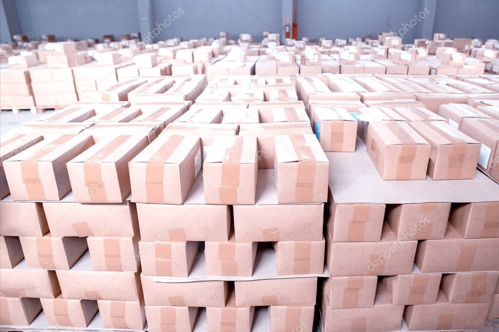 Lots of cardboard boxes in food manufacturing warehouse. Background from boxes on, copy space for text, industry
