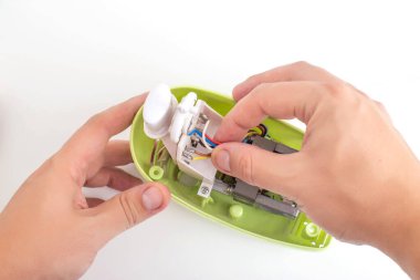 A man repairs a broken kitchen mixer, close-up. Concept for the provision of services for the repair of household appliances, hobby. Repair parts,