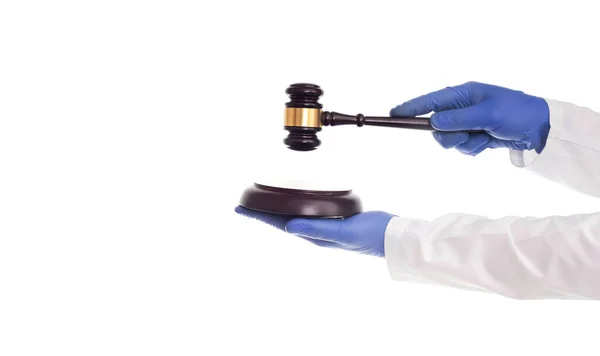 Doctors hands hold a judicial gavel on a white background, isolate. Concept of violation of medical law, negligence of doctors — 스톡 사진