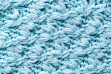 Mavi renk desen, örgü süveter, yakın plan. Sıcak kumaş, yünlü el yapımı.