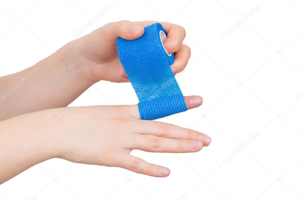 man winds an elastic bandage on his hand on a white background, isolate. The concept of fixation of the digital cleft in case of dislocation, isolated. Bandaging