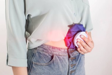 Kız karın ağrısını ve ağrı kesiciyi azaltmak için soğuk algınlığını tıbbi bir torbaya koyuyor. Kayganlaştırıcı ve karın ağrısı için soğuk kompres kavramı