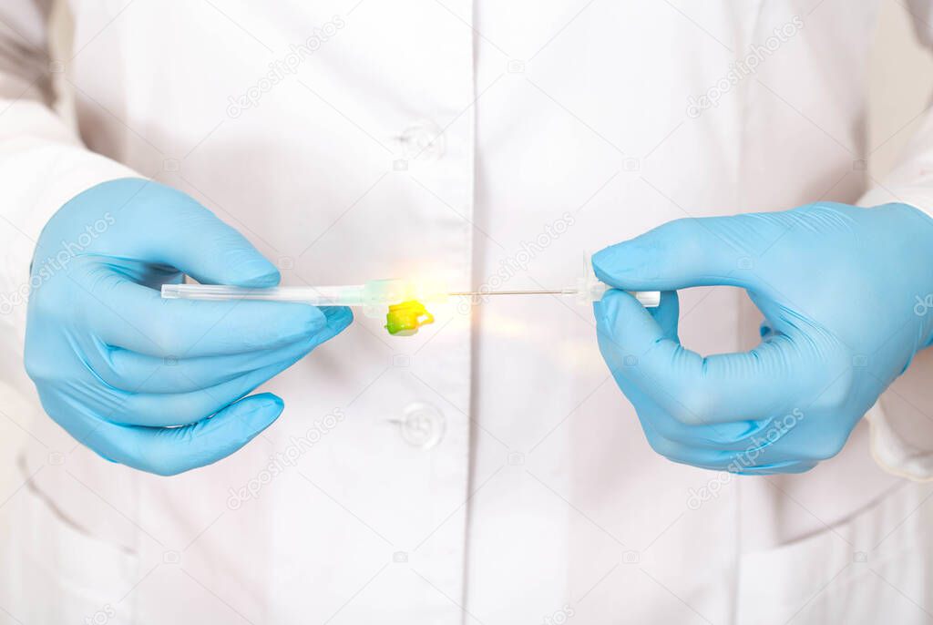 A doctor in medical gloves holds a medical cannula for plastic surgery in cosmetology and dermatology, close-up, procedure