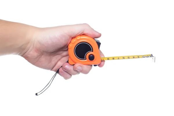 Man engineer holding a measuring tape in his hand on a white background, isolate. Close-up, centimeter — Stock Photo, Image
