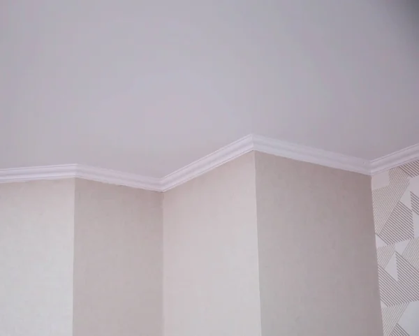 Wall with different angles and skirting boards in the room. Design solution for renovation in an apartment