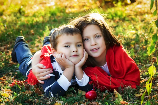 Children lie on the autumn grass Royalty Free Stock Images
