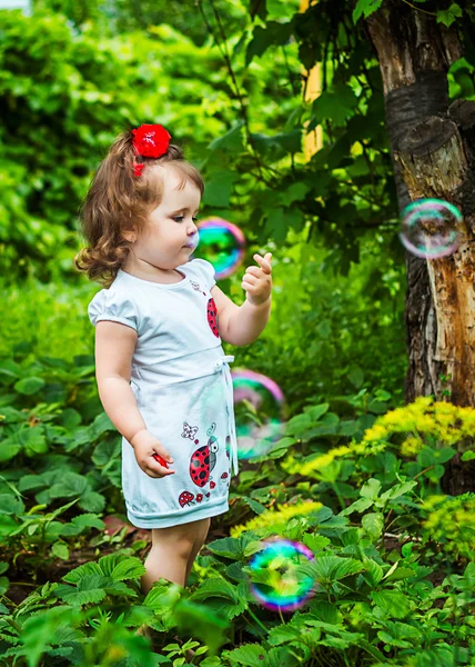 Portrait of a beautiful girl among the flowers — Stock Photo, Image