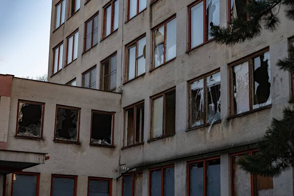 Abandoned Soviet-era building with broken windows under a gloomy sky