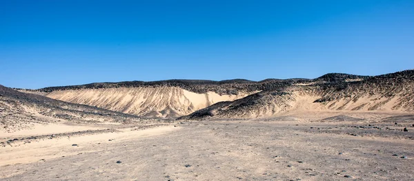 Black desert lanscape and basalt formarions — Stock Photo, Image