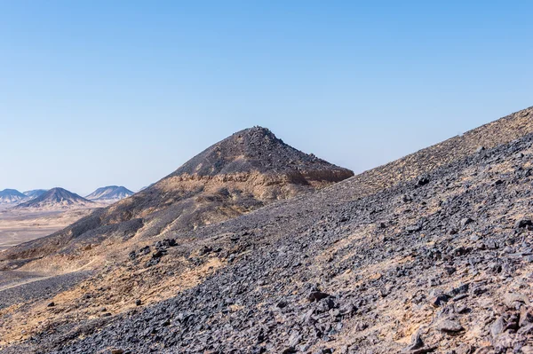 Black desert lanscape and basalt formarions — Stock Photo, Image