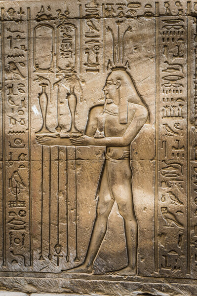 Egyptian hieroglyphs on the wall of the Horus temple in Egypt