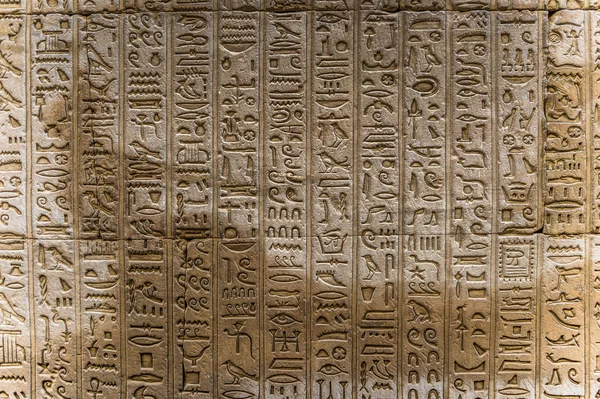 Egyptian hieroglyphs on the wall of the Horus temple in Egypt