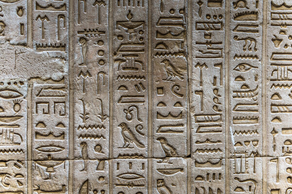 Egyptian hieroglyphs on the wall of the Horus temple in Egypt