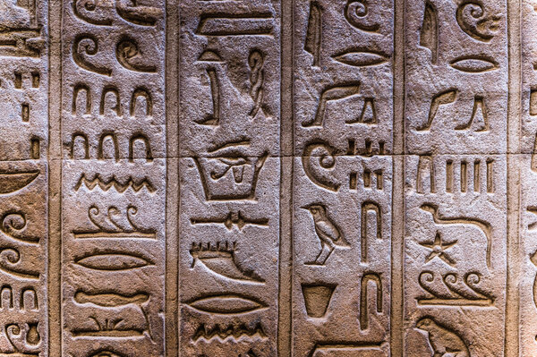 Egyptian hieroglyphs on the wall of the Horus temple in Egypt