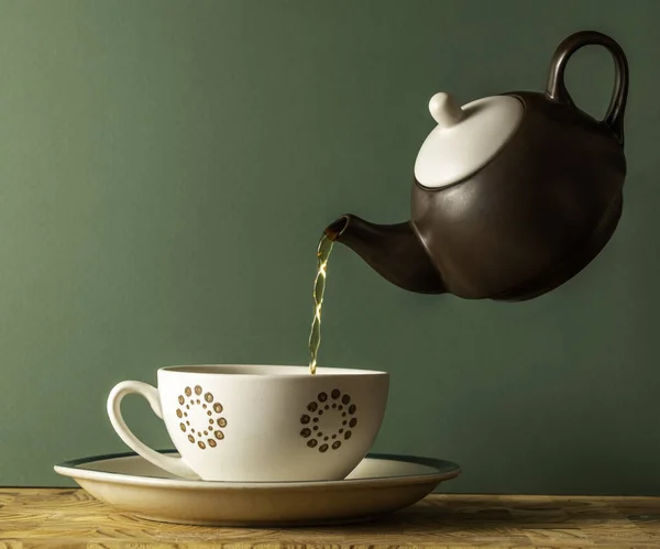 Levitating Teapot Filling Cup Isolated Green Stock Photo