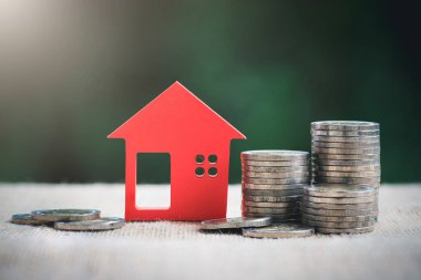 Model ev ve bozuk para yığını. Ev satın alma, ipotek ve gayrimenkul yatırımı için para biriktirme.
