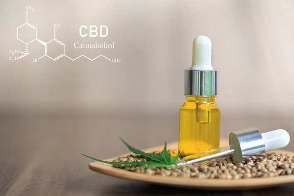 CBD composition in cannabis, cannabis oil in glass bottle, organic cannabis oil, alternative herbal medicine concept. Organic herbs. Scientific cannabis symbol.