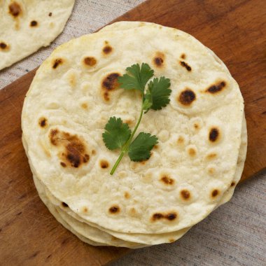 Ev yapımı Roti Chapati tahta üzerinde düz ekmek, tepeden bakıldığında. Üst manzara, yukarıdan, düz yatıyordu. Yakın plan..