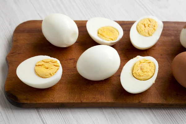 Hard Boiled Eggs on a rustic wooden board, low angle view. Close-up.