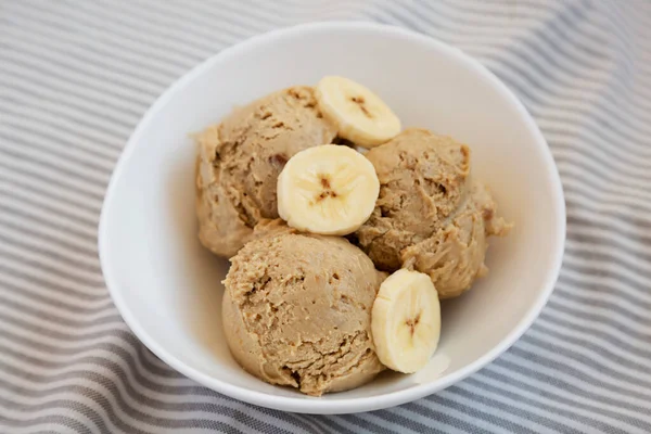 Homemade Peanut Butter Banana Ice Cream in a Bowl, side view. Close-up.