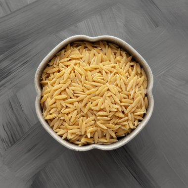Tabakta çiğ organik orzo makarna, üst manzara. Yukarıdan, yukarıdan, dümdüz.