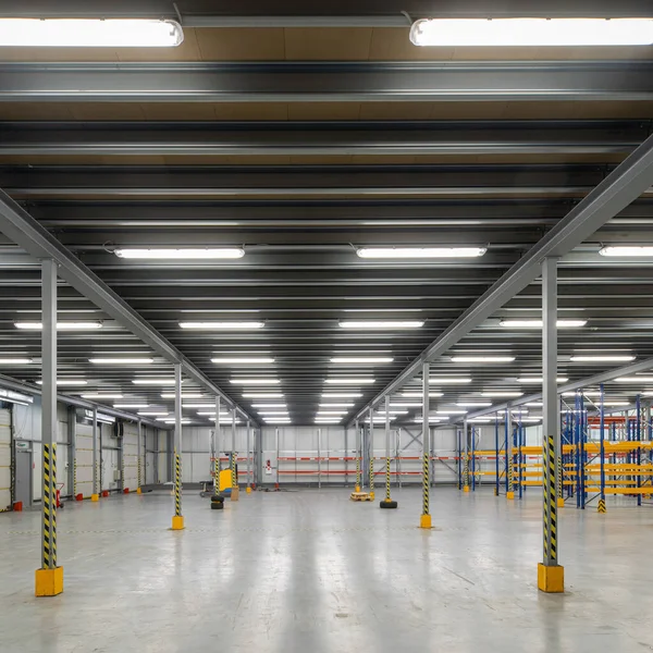 Industrial architecture. Modern interior of huge empty storehouse. New distribution warehouse with rack stack. Metal construction.