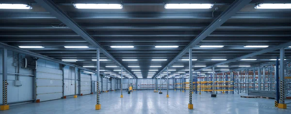 Industrial architecture. Modern interior of huge empty storehouse. New distribution warehouse with rack stack. Metal construction.