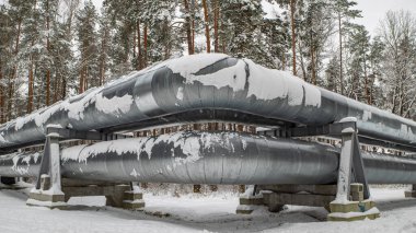 Merkezi ısıtma sisteminin devasa endüstriyel boru hatları. Borularda kar.