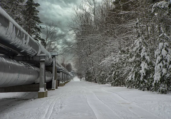 Huge industrial pipelines of central heating system. Snow on pipes. — Stock Photo, Image