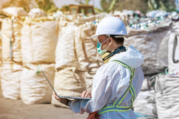 Waste processing plant. Technological process plastic bottles at the factory for processing and recycling. The worker recycling factory,engineers is out of focus or blurred.