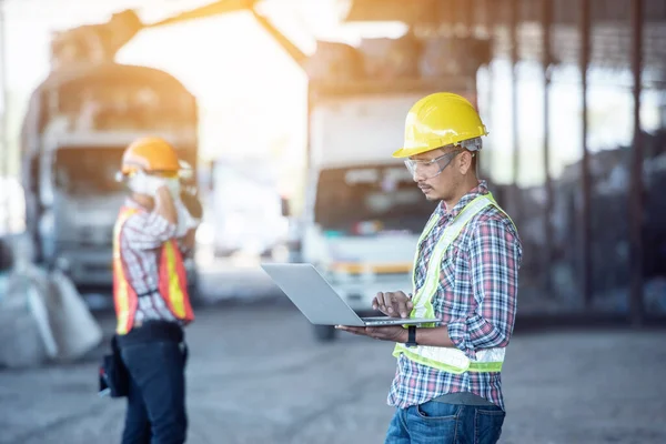 Professional Industrial Mechanical Engineer with Factory Worker while Using Laptop Computer at Metal lathe industrial manufacturing factory. Engineer Operating are working on projects in factory