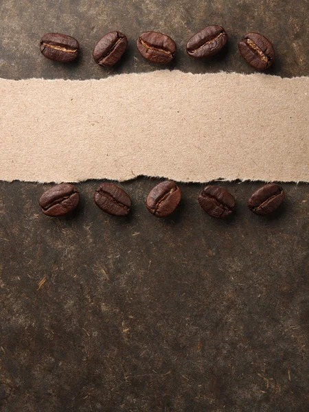 Coffee crop beans with paper on wood texture background — Stock Photo, Image