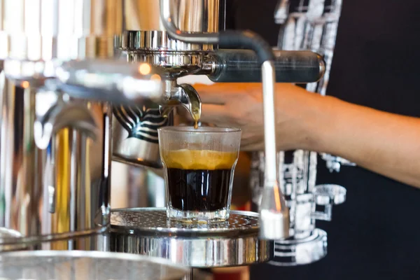 Espresso machine pouring coffee in glass — Stock Photo, Image