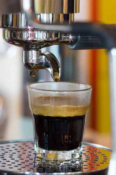 Espresso machine pouring coffee in glass Stock Photo