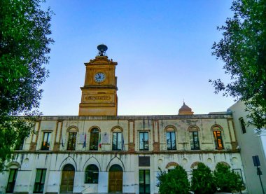 Günbatımında Bernalda 'da şehir merkezi ve saat kulesi, Matera bölgesi, Basilicata, İtalya.