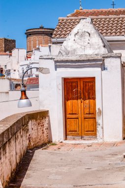 Pisticciand its white buildings from Rione Dirupo, wooden door, Matera, Basilicata, Italy, Europe.